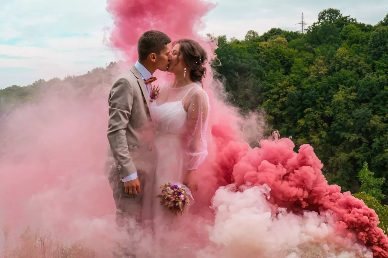 bride and groom with pink dust